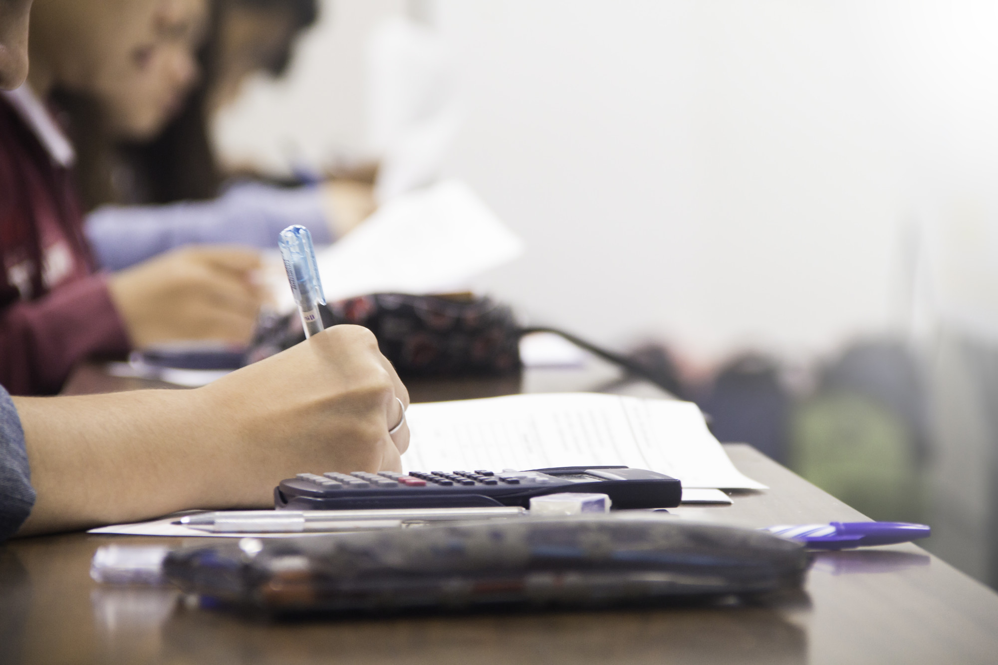 university-students-quiz-test-studies-from-teacher-large-lecture-room-students-uniform-attending-exam-classroom-educational-school.jpg